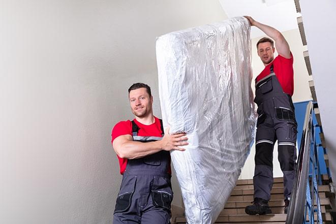 bed removal experts transporting a box spring in Three Rivers